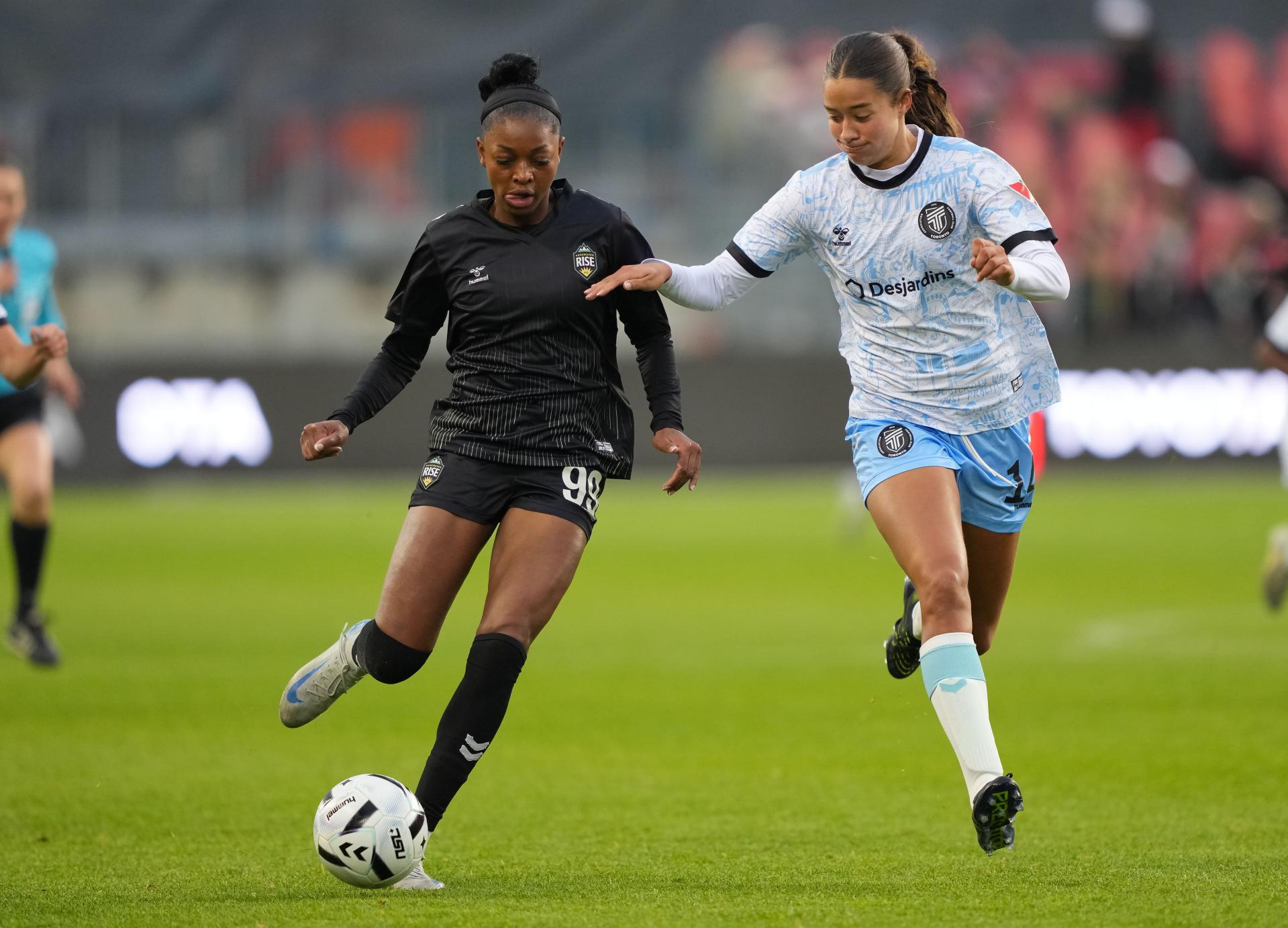 Vancouver Rise FC v AFC Toronot, Latifah Abdu with the ball while being defended by Sarah Rollins